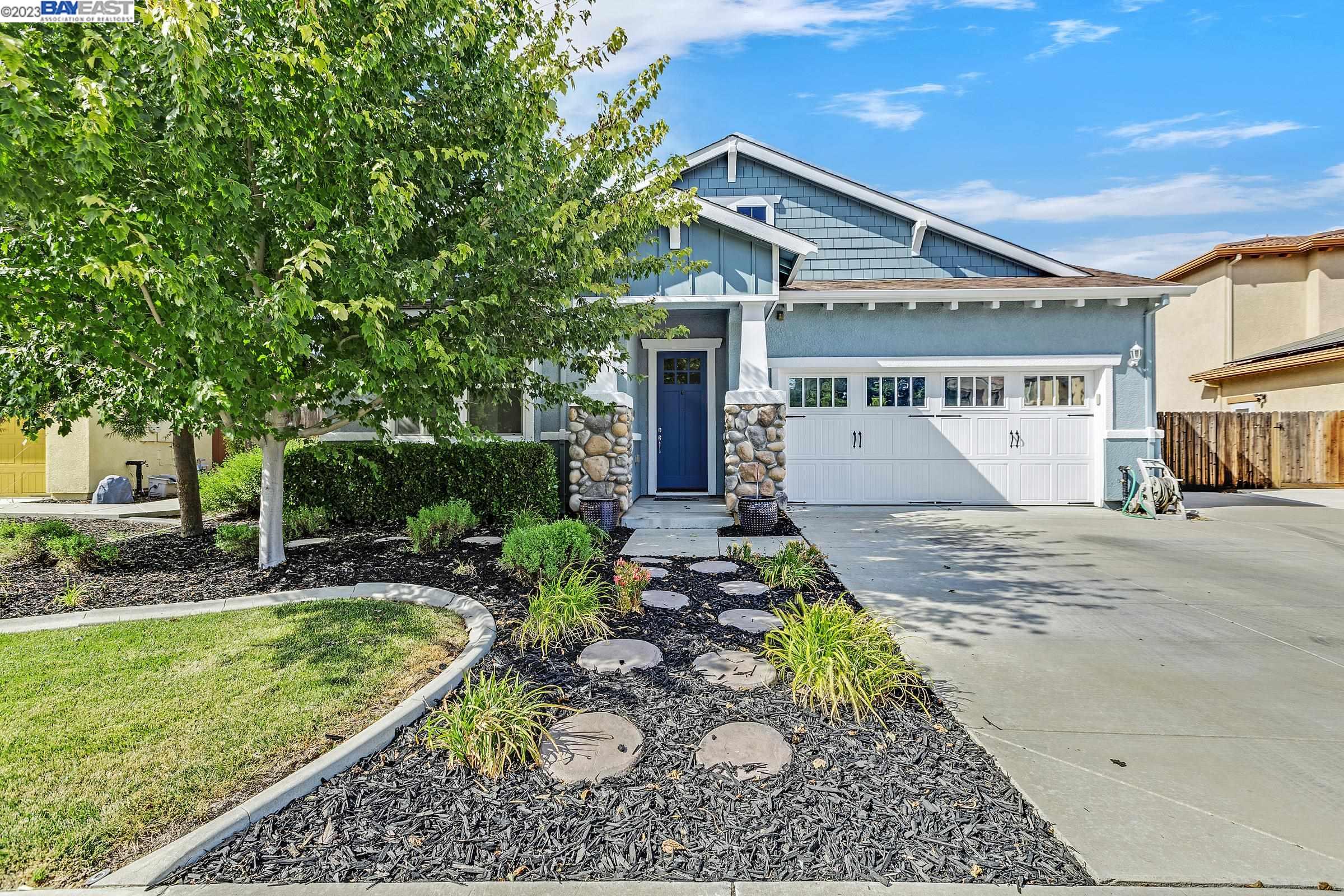 691 Cathedral Way Tracy, CA 95304 - Photo 1 of 1 a front view of a house with garden