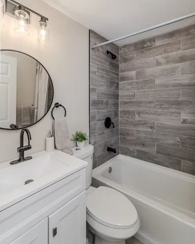 a bathroom with a sink toilet and shower