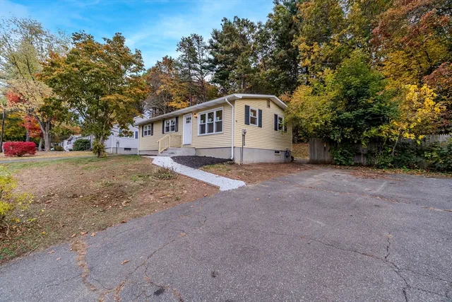 a house that has a tree in front of it