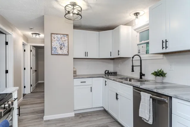 a kitchen with stainless steel appliances granite countertop a sink and a stove top oven