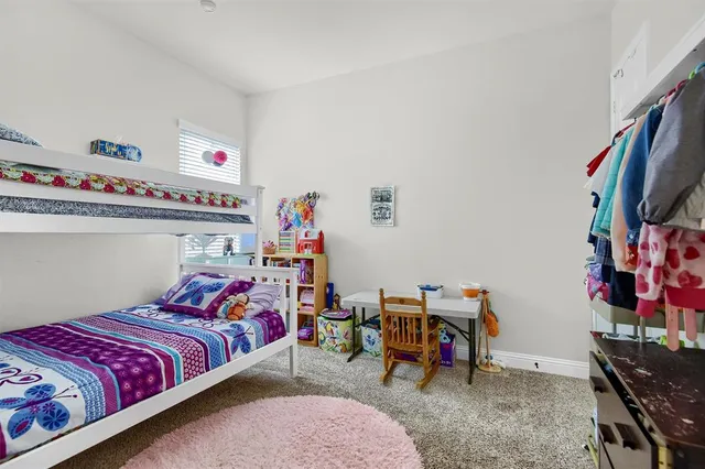 a bedroom with bed and a flat tv screen