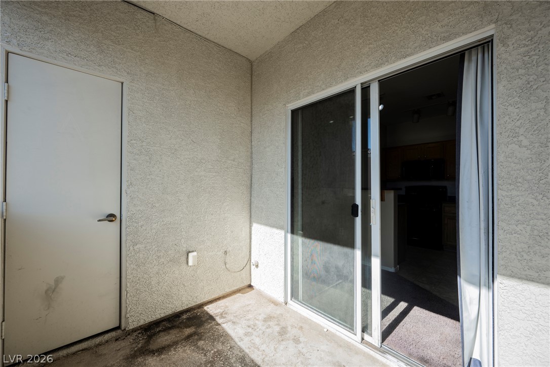 6320 Snap Ridge Street, Unit 201 North Las Vegas, NV 89081 - Photo 26 of 56 A private patio space offering seamless indoor-outdoor living through sliding glass doors.