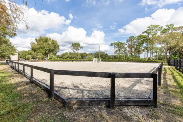 a view of a yard with wooden fence