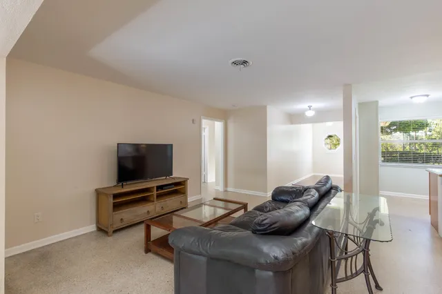 an empty room with windows and outdoor view