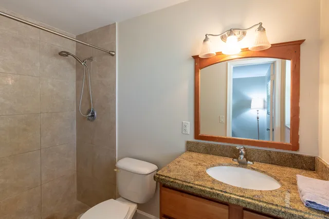 a bedroom with a bed and lamp