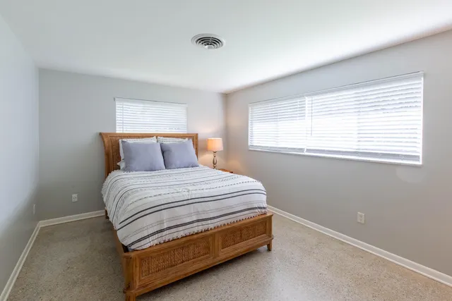 a bedroom with a bed and a lamp