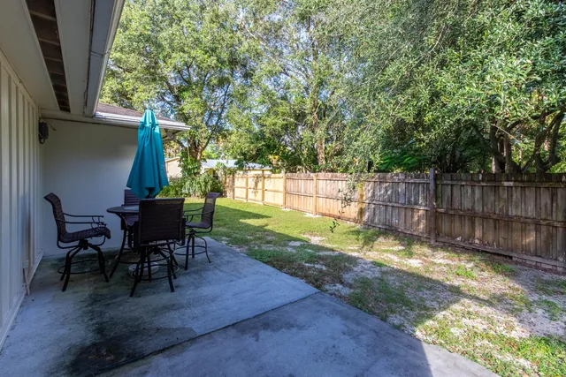 a view of a sitting area with furniture and wooden fence