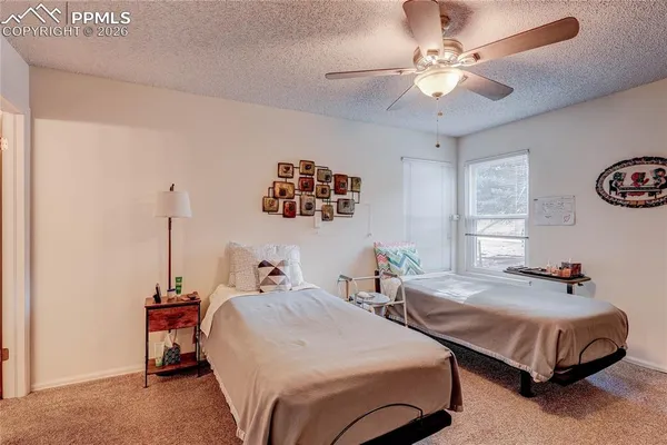 a bedroom with two beds and a chandelier