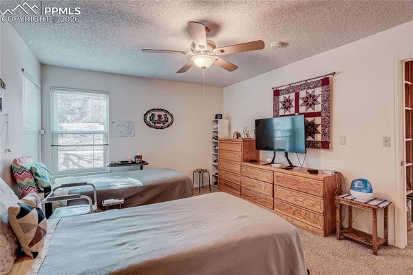 a bedroom with furniture and a flat screen tv