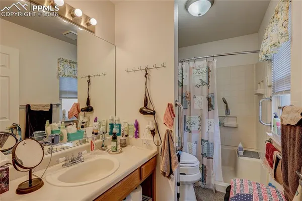 a bathroom with a sink vanity mirror and toilet