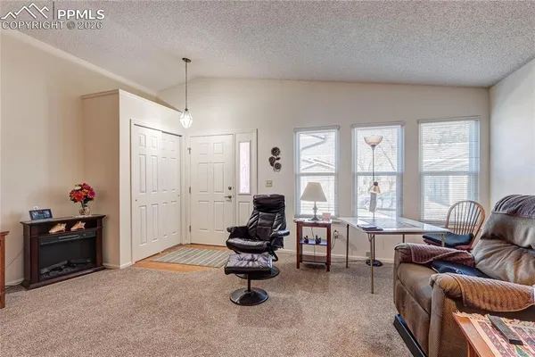 a living room with furniture and a chandelier
