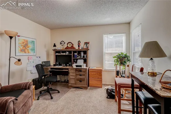 a view of a workspace with furniture and a workspace