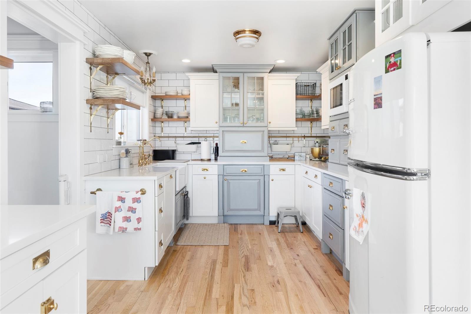2073 South Perry Park Road Sedalia, CO 80135 - Photo 14 of 41 a kitchen with white cabinets sink and white appliances