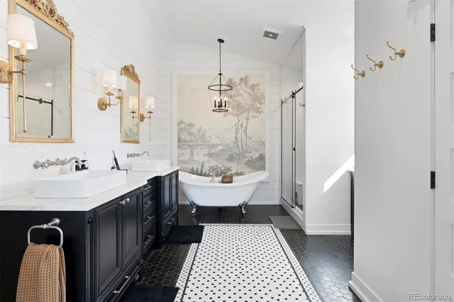 a bathroom with a sink a toilet a mirror and shower