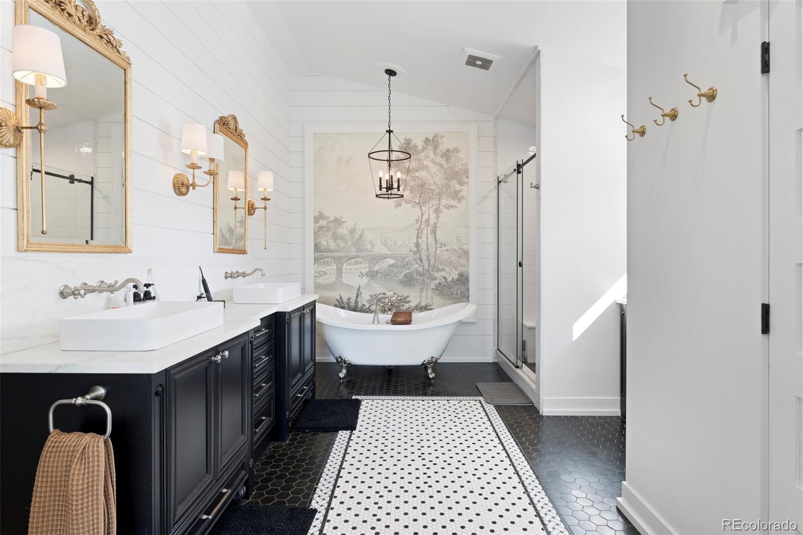 2073 South Perry Park Road Sedalia, CO 80135 - Photo 19 of 41 a bathroom with a sink a toilet a mirror and shower