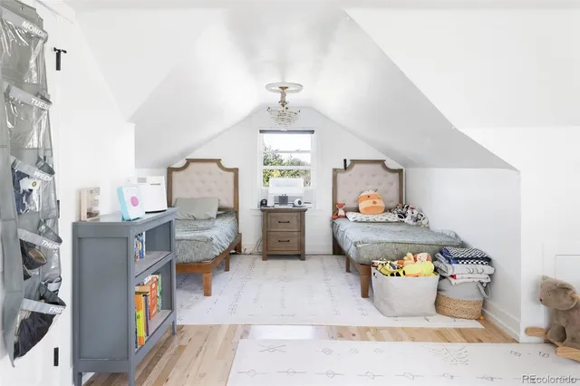 a bedroom with furniture and a large window