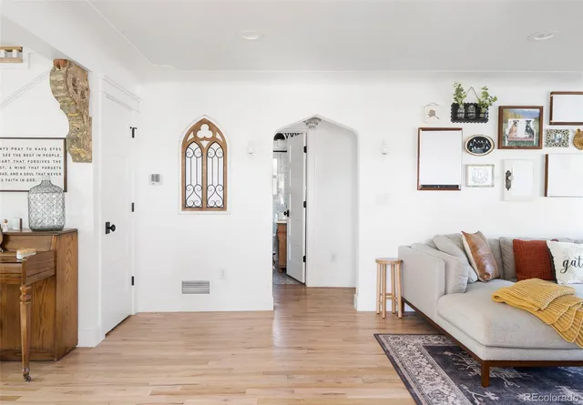 a living room with furniture and painting on the wall