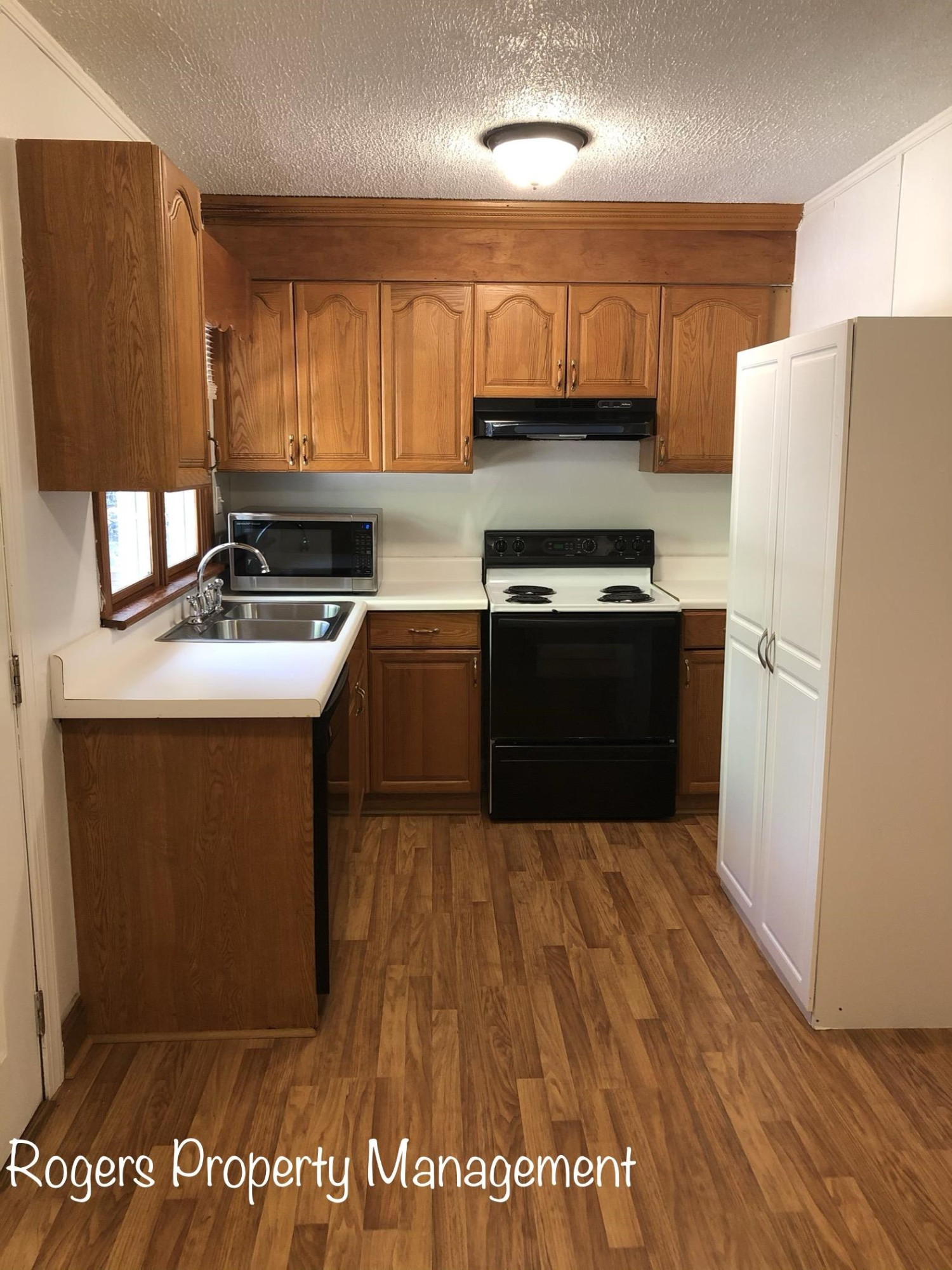 5409 Bobbitt Road Apex, NC 27539 - Photo 6 of 19 a kitchen with stainless steel appliances granite countertop a stove a refrigerator a sink and dishwasher with wooden floor