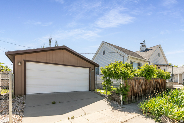 59 East Pinehurst Street Tooele, UT 84074 - Photo 19 of 22 Detached garage with a white overhead door and brown siding