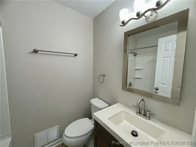 a bathroom with a sink a toilet and mirror