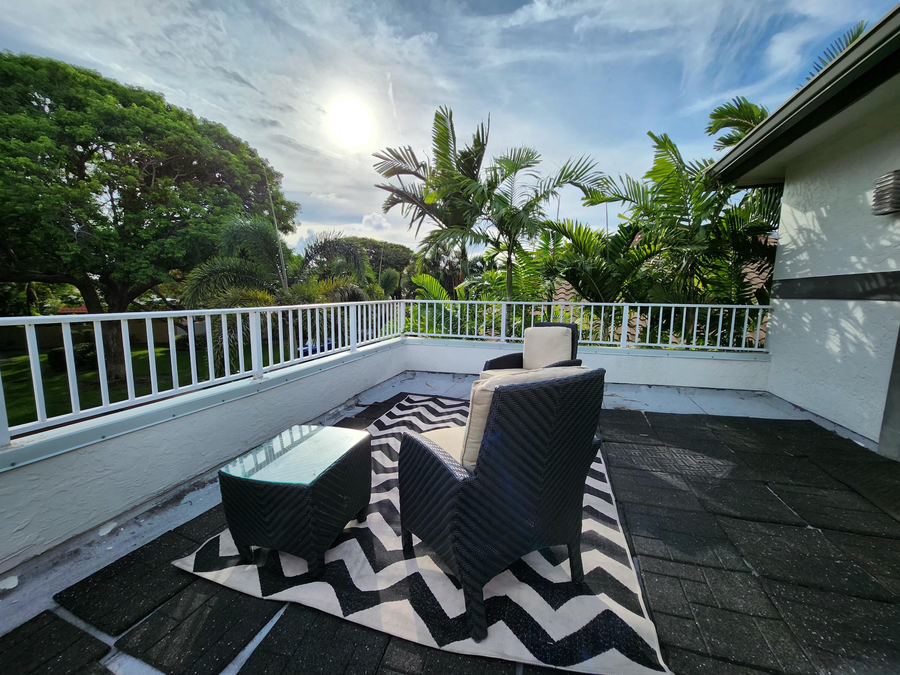 3567 Commodore Circle Delray Beach, FL 33483 - Photo 74 of 76 a view of a chair and tables in the balcony