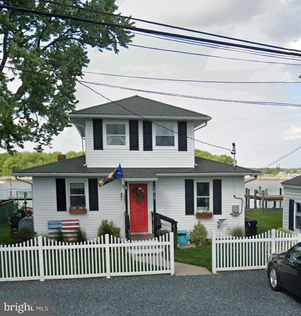 Charming waterfront home with vibrant entrance.