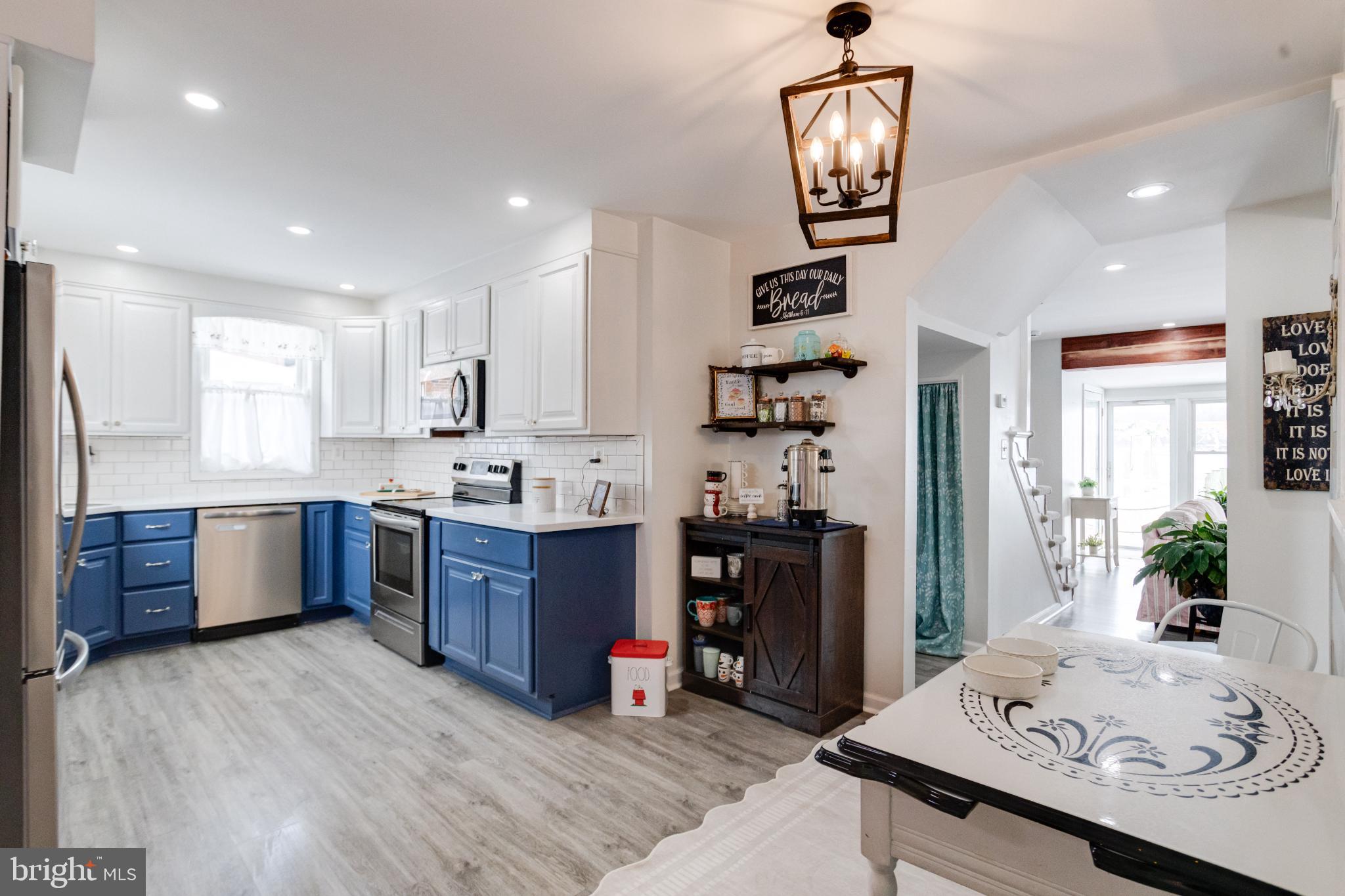 1815 Wilson Point Road Middle River, MD 21220 - Photo 12 of 76 a kitchen with stainless steel appliances granite countertop a sink dishwasher stove and refrigerator with wooden floor