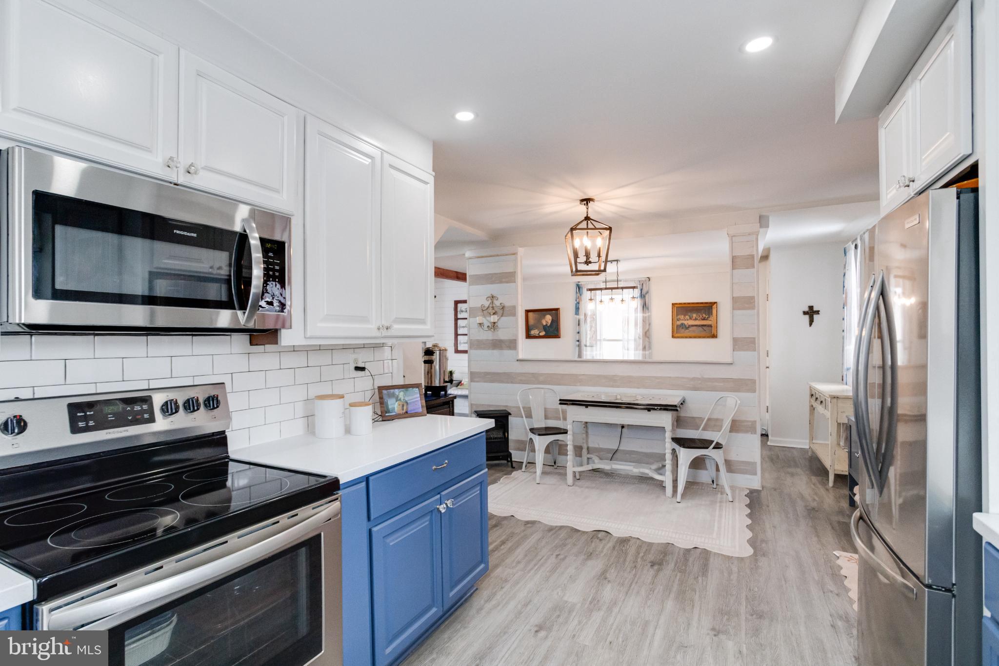 1815 Wilson Point Road Middle River, MD 21220 - Photo 16 of 76 a kitchen with stainless steel appliances a stove sink microwave and cabinets