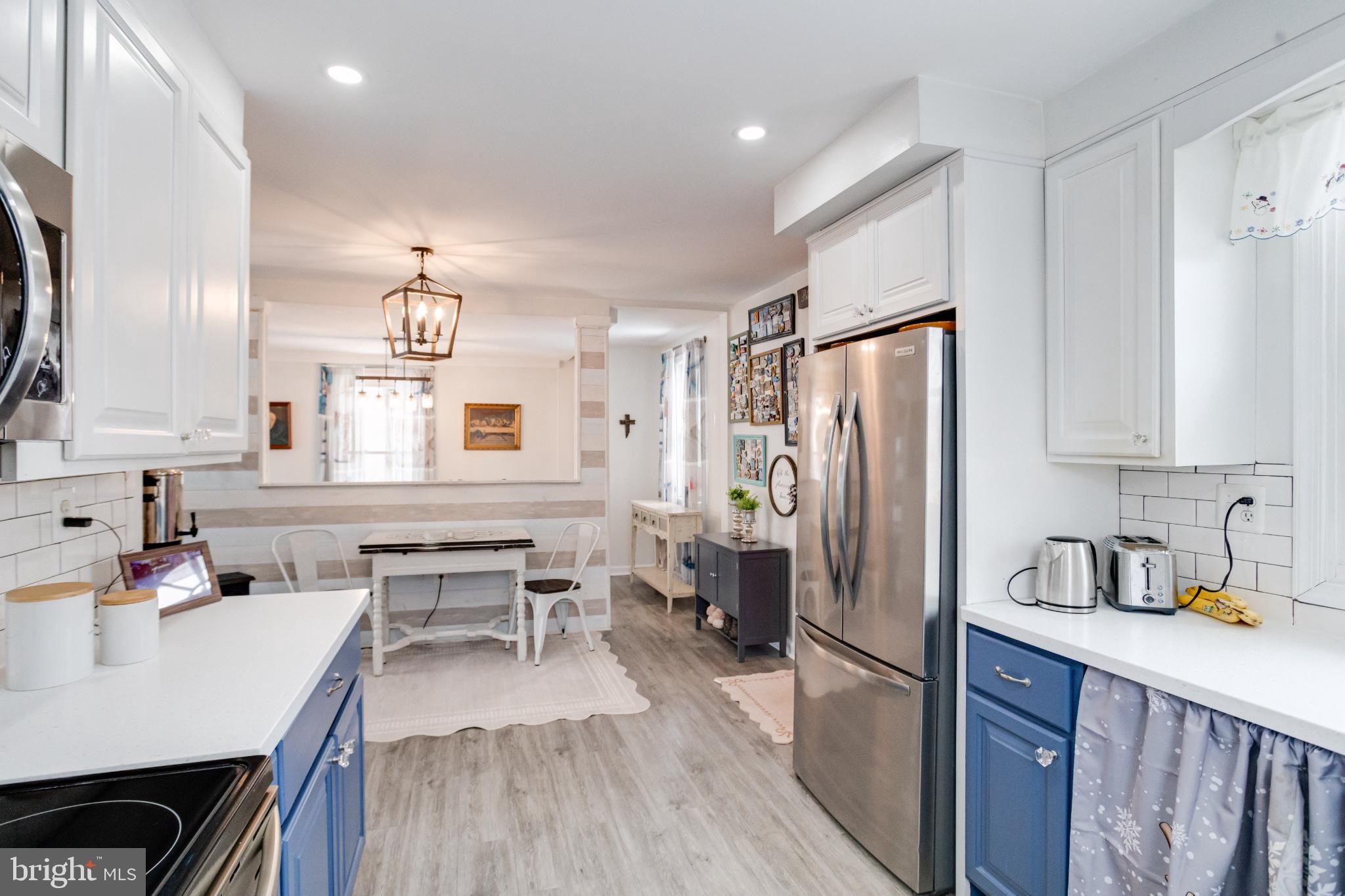 1815 Wilson Point Road Middle River, MD 21220 - Photo 17 of 76 a kitchen with refrigerator cabinets and wooden floor