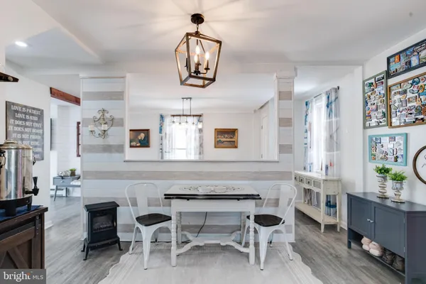 a living room with furniture a chandelier and a flat screen tv