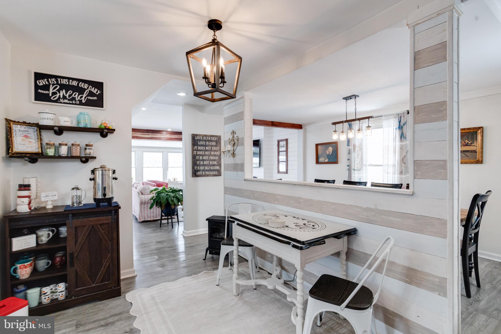 1815 Wilson Point Road Middle River, MD 21220 - Photo 19 of 76 a kitchen with stainless steel appliances a stove a sink and a dining table with wooden floor