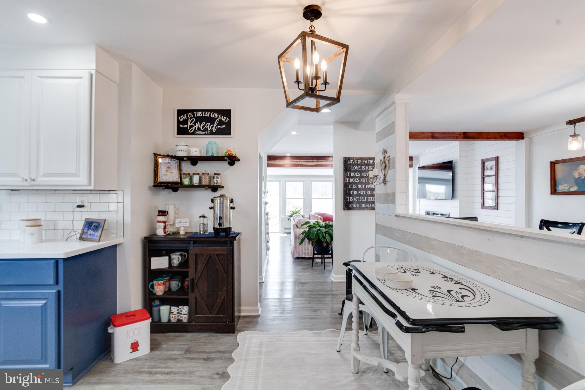 1815 Wilson Point Road Middle River, MD 21220 - Photo 20 of 76 a living room with furniture a chandelier and a flat screen tv