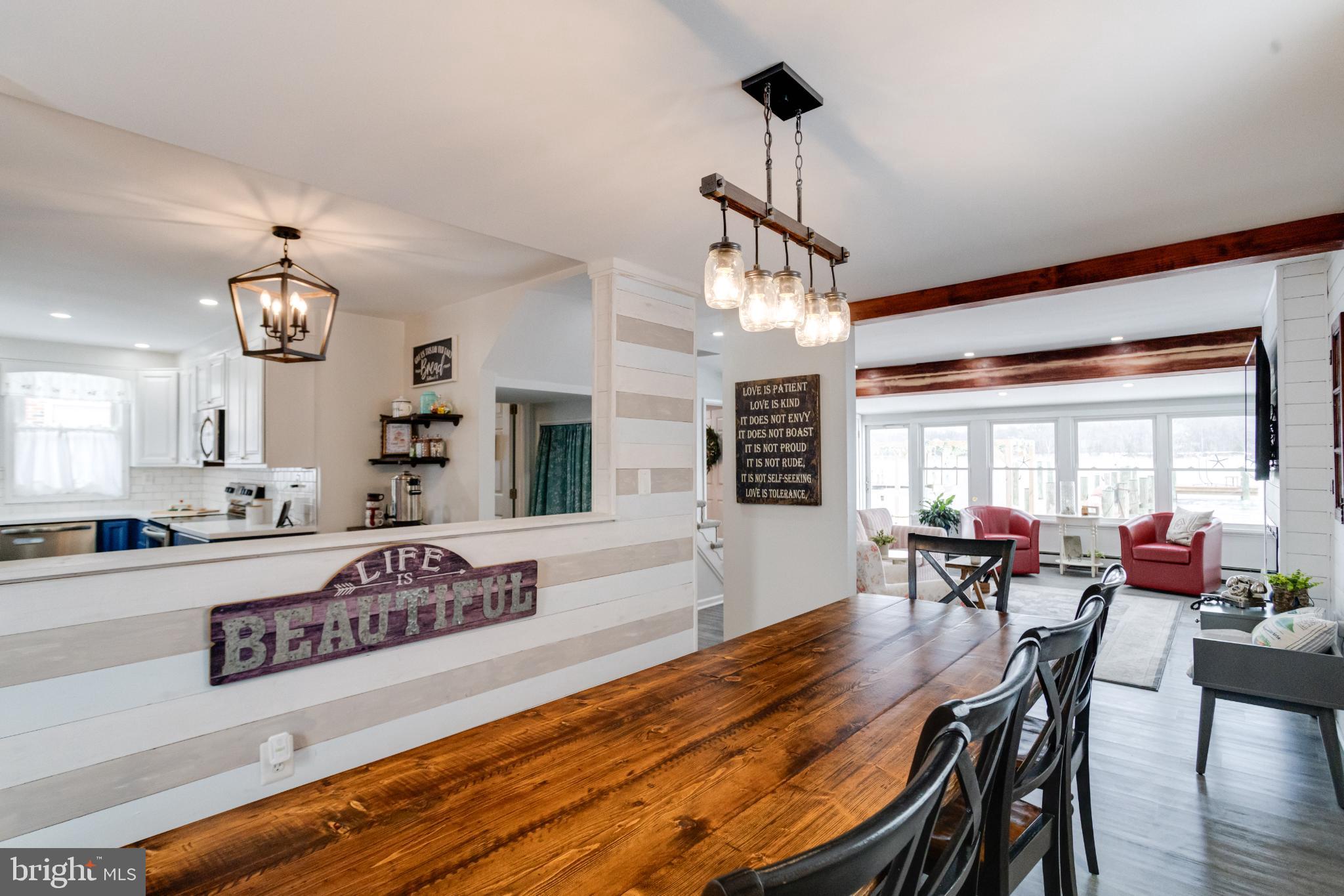 1815 Wilson Point Road Middle River, MD 21220 - Photo 24 of 76 a view of a dining room and livingroom with furniture wooden floor a chandelier