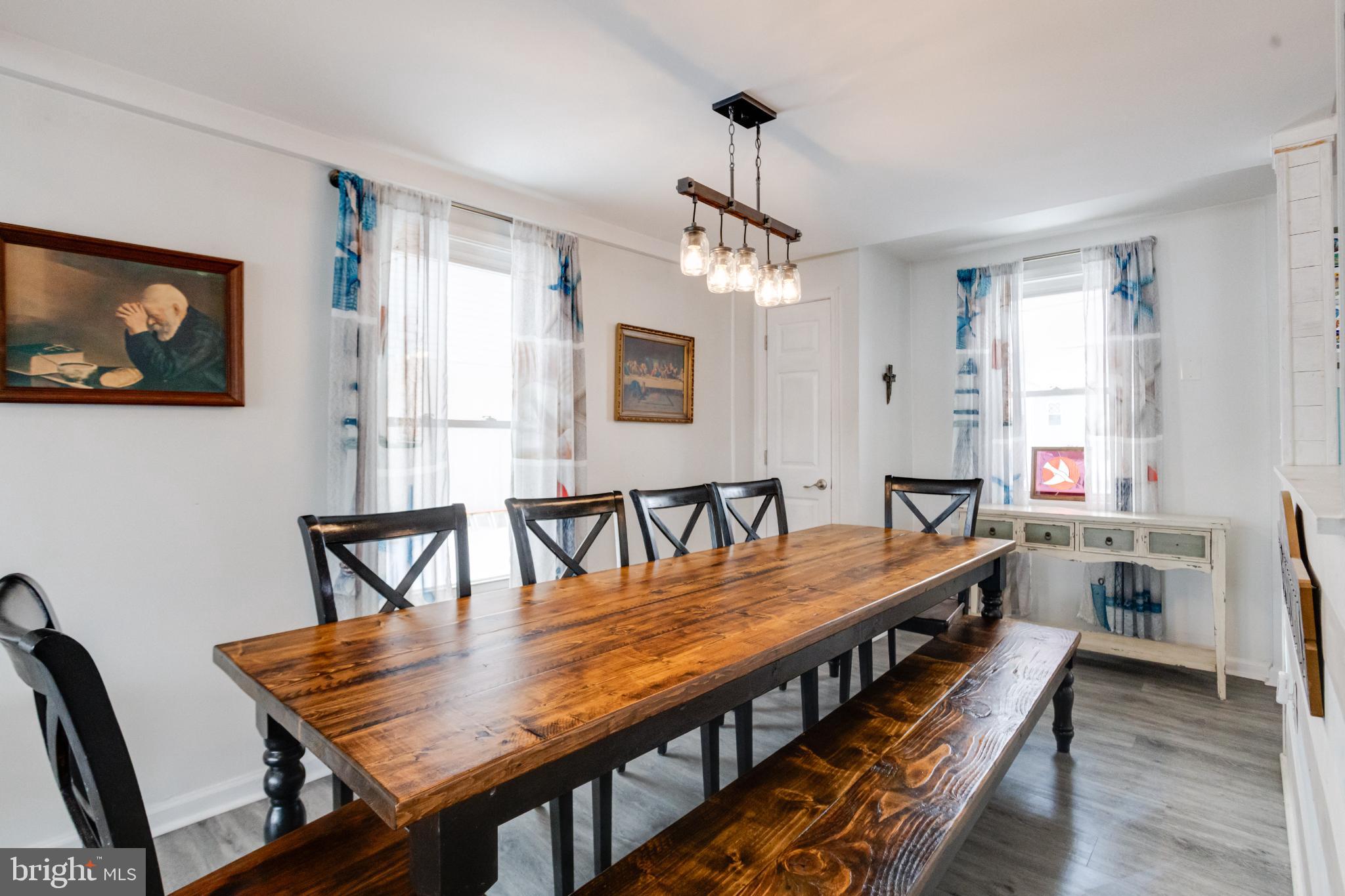 1815 Wilson Point Road Middle River, MD 21220 - Photo 27 of 76 a dining room with furniture a chandelier and wooden floor