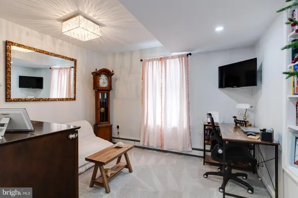 a view of a livingroom with furniture and a bookshelf