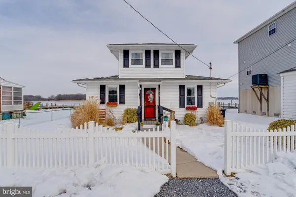 a view of a house with wooden fence
