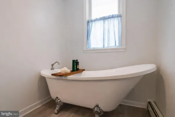 a bedroom with a bed and a flat tv screen on the dresser