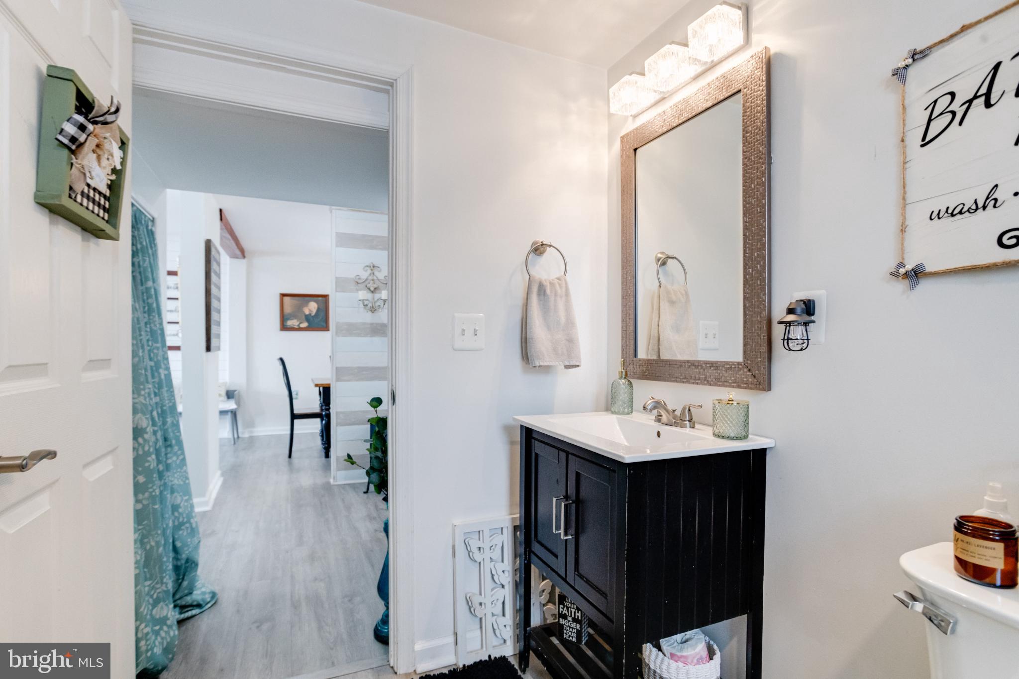 1815 Wilson Point Road Middle River, MD 21220 - Photo 35 of 76 a en suite bathroom with a sink and a mirror
