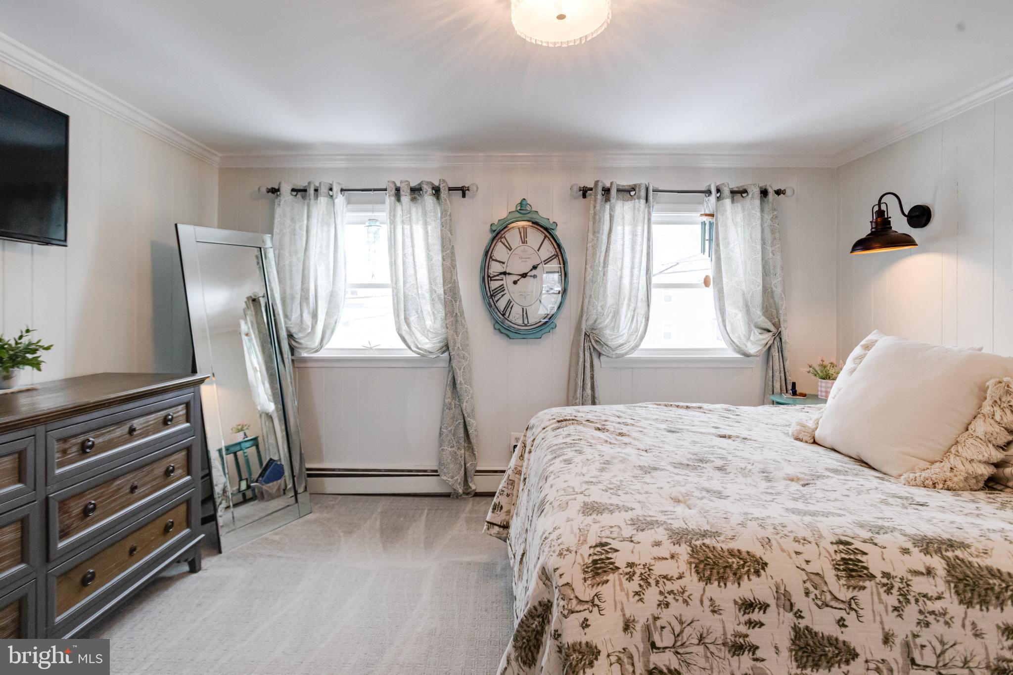 1815 Wilson Point Road Middle River, MD 21220 - Photo 37 of 76 a bedroom with a bed and a flat tv screen on the dresser