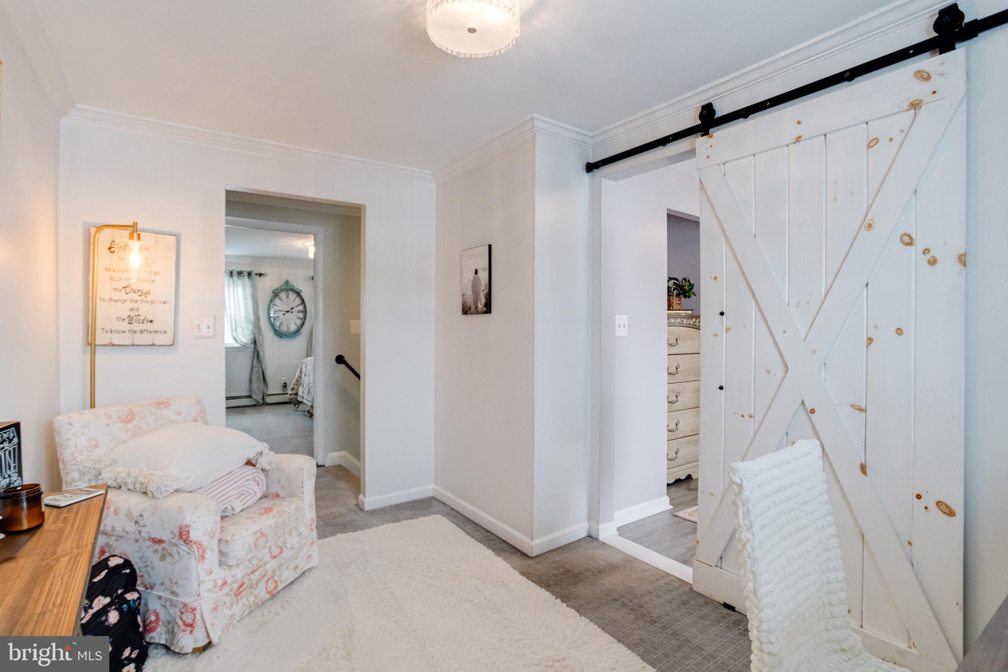 1815 Wilson Point Road Middle River, MD 21220 - Photo 42 of 76 a spacious bedroom with a bed and a chandelier