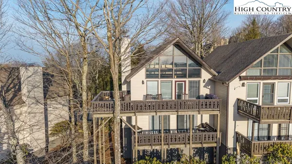 a front view of a house with a tree