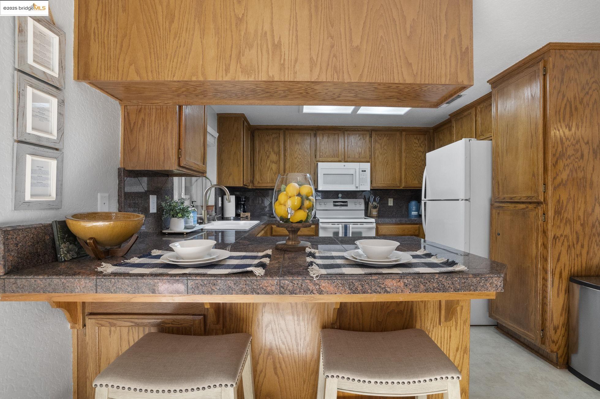 12080 Breckenridge Road Groveland, CA 95321 - Photo 12 of 48 a kitchen with a sink a stove and a refrigerator