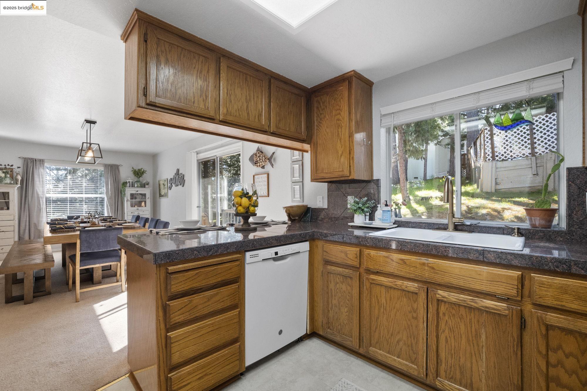 12080 Breckenridge Road Groveland, CA 95321 - Photo 14 of 48 a kitchen with sink cabinets and window