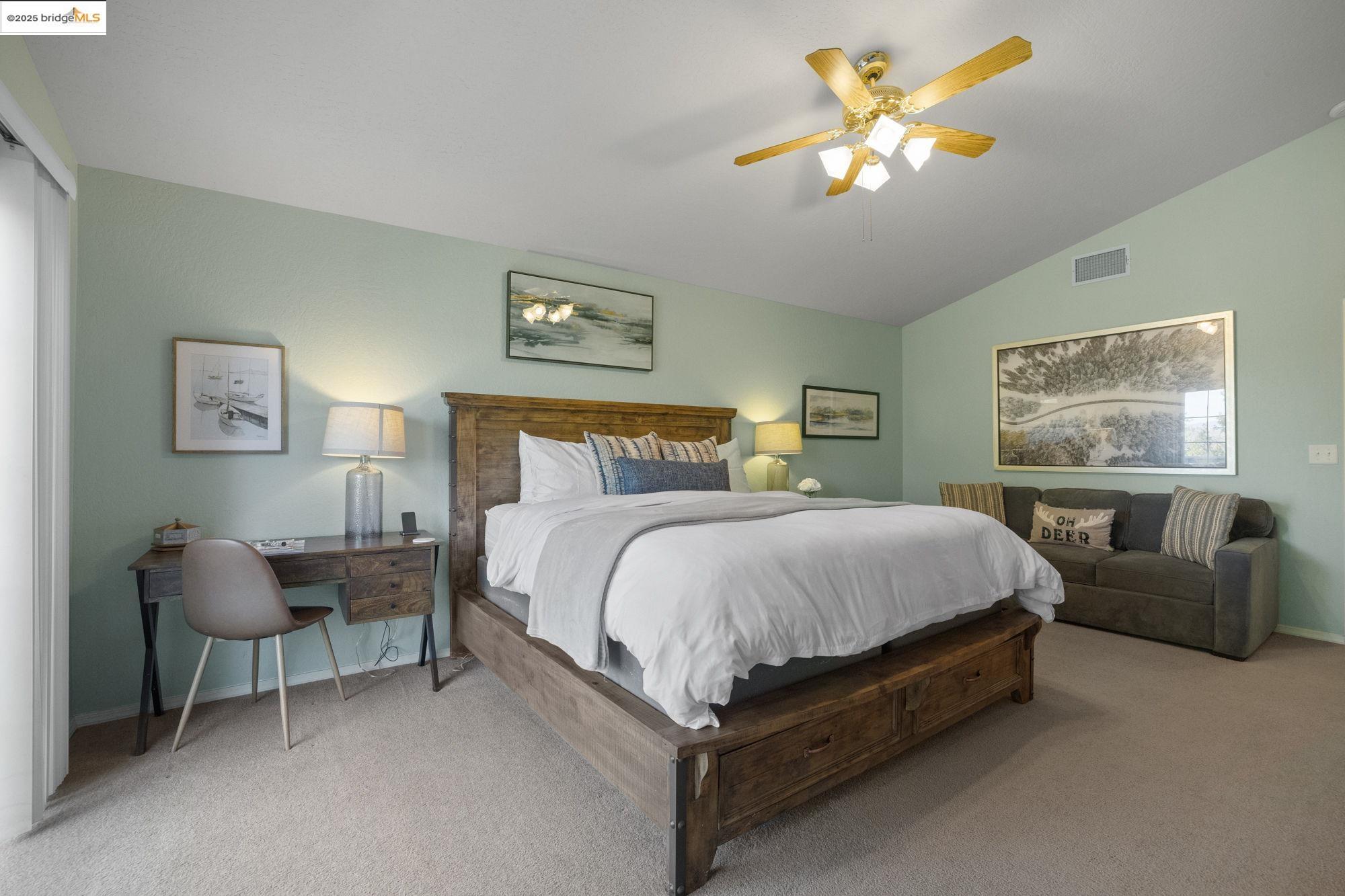 12080 Breckenridge Road Groveland, CA 95321 - Photo 21 of 48 a spacious bedroom with a bed and a chandelier