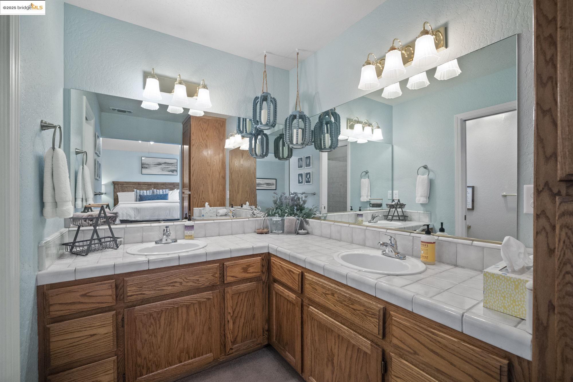 12080 Breckenridge Road Groveland, CA 95321 - Photo 22 of 48 a bathroom with a double vanity sink and a mirror