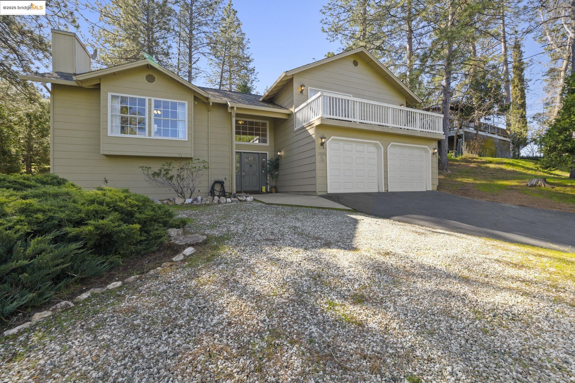 12080 Breckenridge Road Groveland, CA 95321 - Photo 30 of 48 a front view of a house with a yard and garage