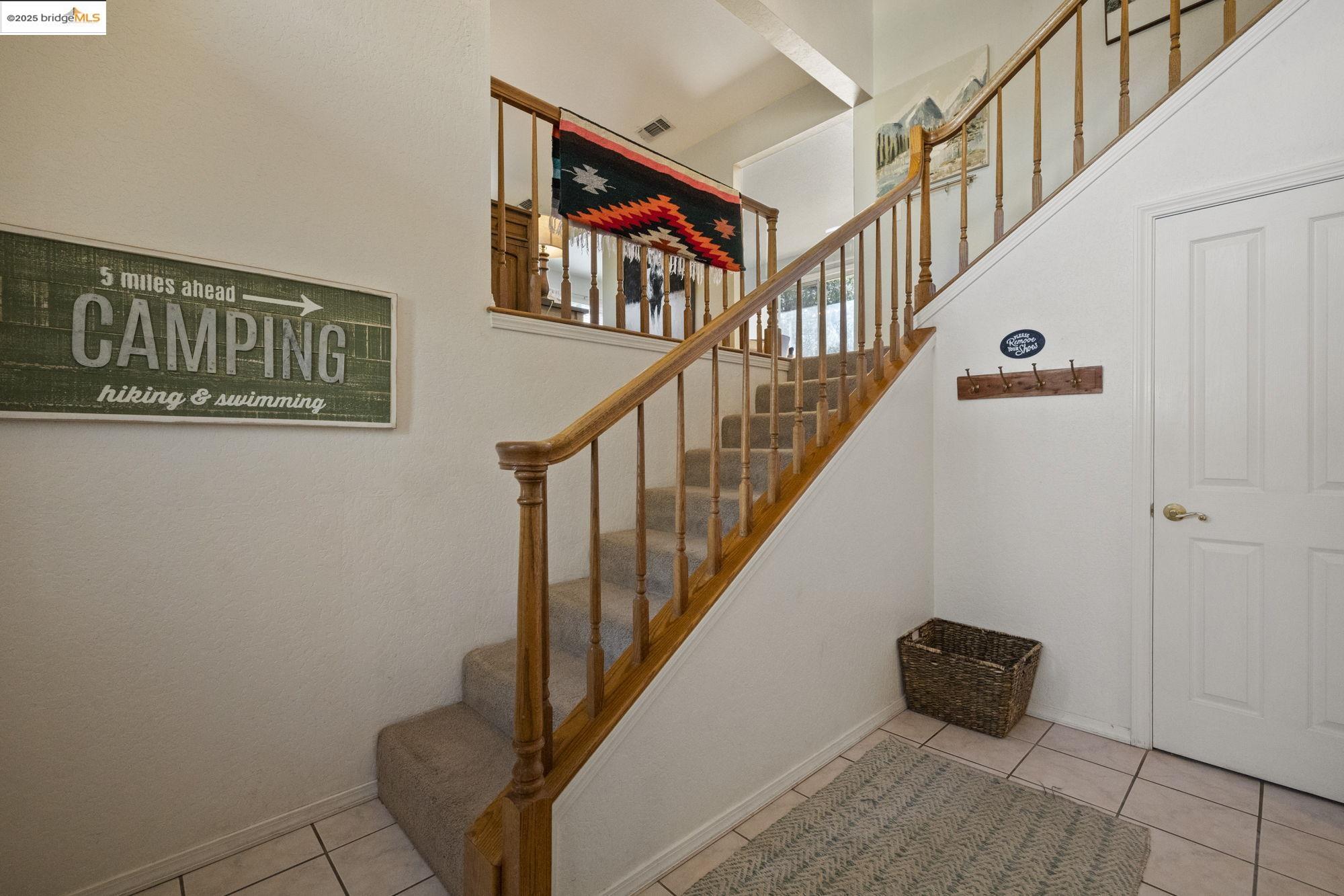 12080 Breckenridge Road Groveland, CA 95321 - Photo 4 of 48 a view of staircase with lots of frames on wall and a window