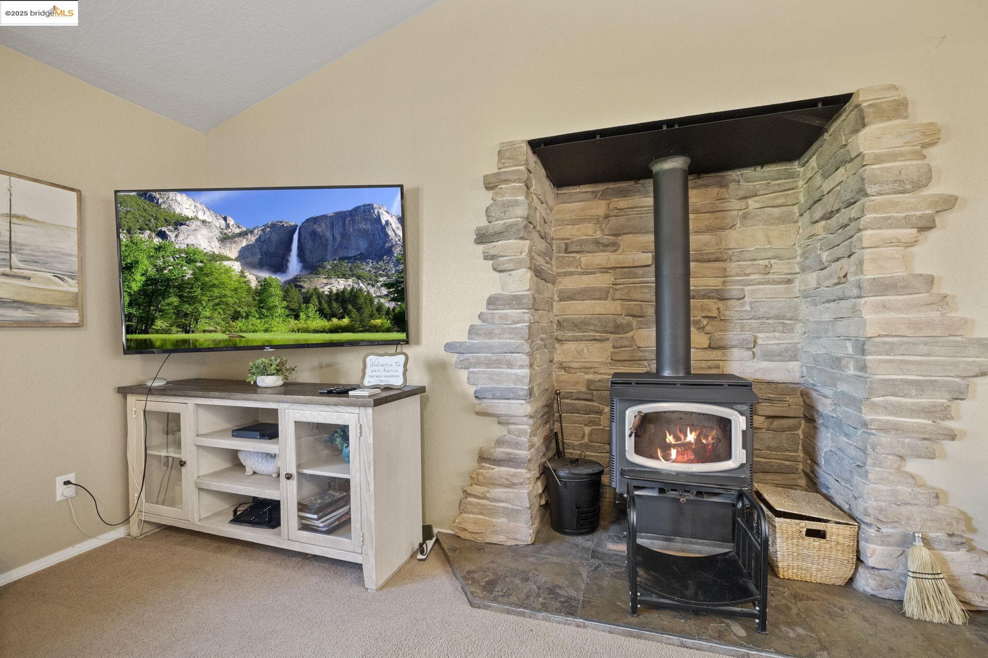 12080 Breckenridge Road Groveland, CA 95321 - Photo 7 of 48 a living room with a flat screen tv and a fireplace