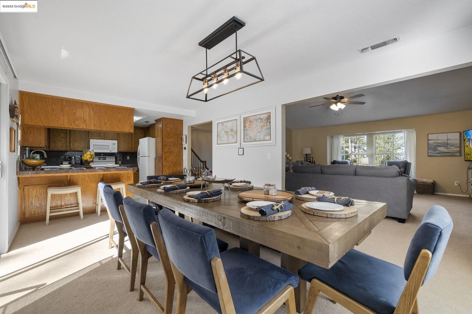 12080 Breckenridge Road Groveland, CA 95321 - Photo 10 of 48 a dining room with wooden floor a chandelier a wooden table and chairs