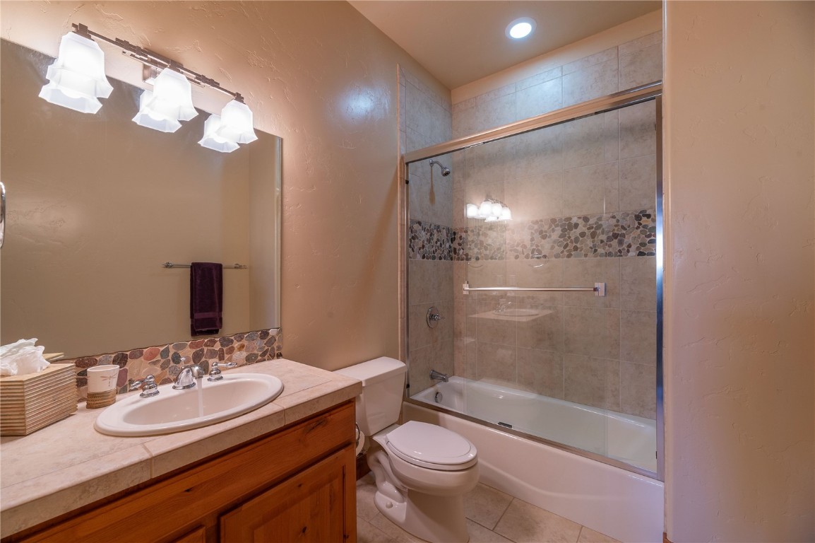 2206 Hamilton Creek Road Silverthorne, CO 80498 - Photo 26 of 39 Full bathroom featuring enclosed tub / shower combo, vanity, and tile patterned flooring